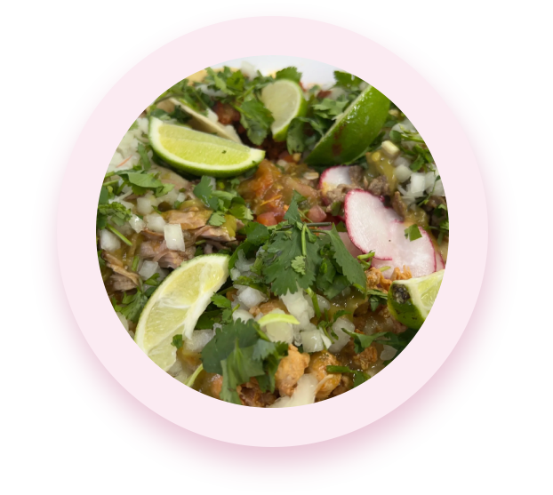 A plate of food with lime and cilantro.